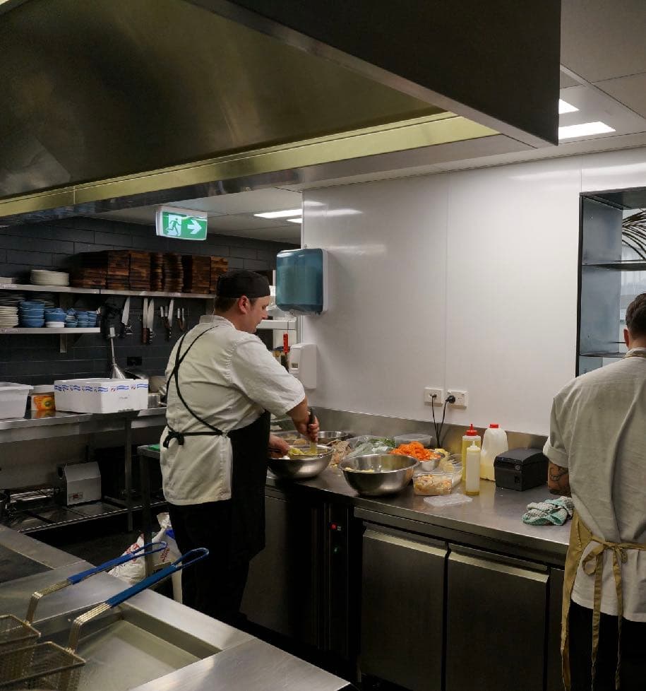 Working restaurant kitchen with Hydrapanel walls