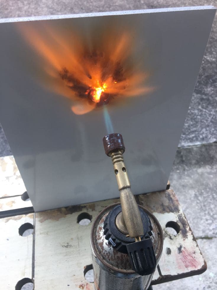 Blowtorch fire test against a Hydrapanel sheet — the panel face resists the flame
