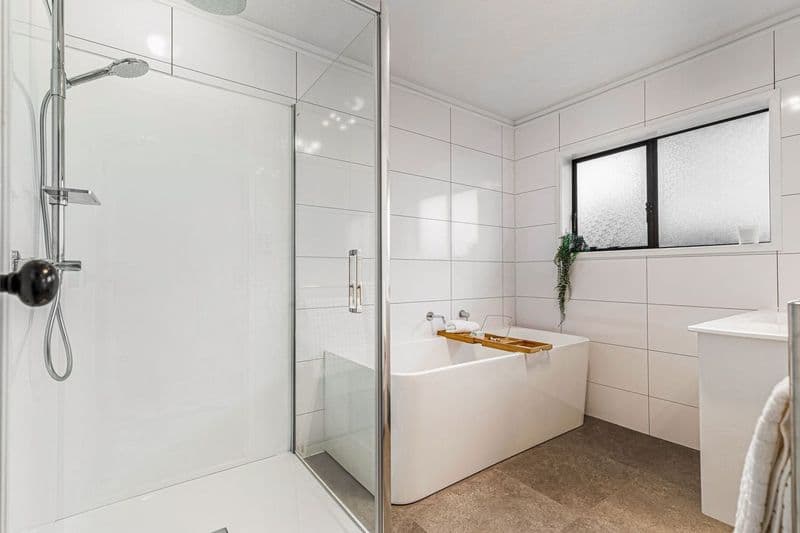 Residential bathroom with freestanding bath, walls lined in Hydratile large-format tile panels