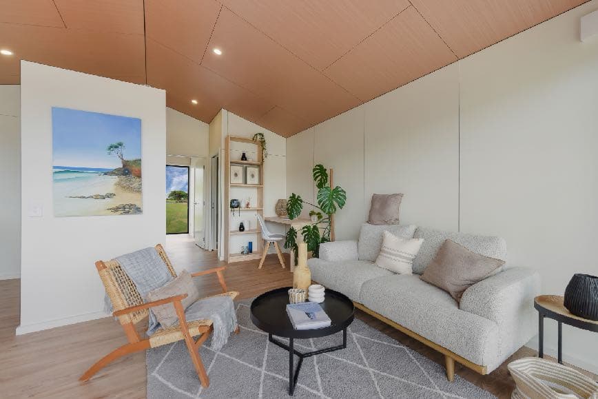 Living room with pre-finished panel walls and woodgrain ceiling — no plaster, no paint