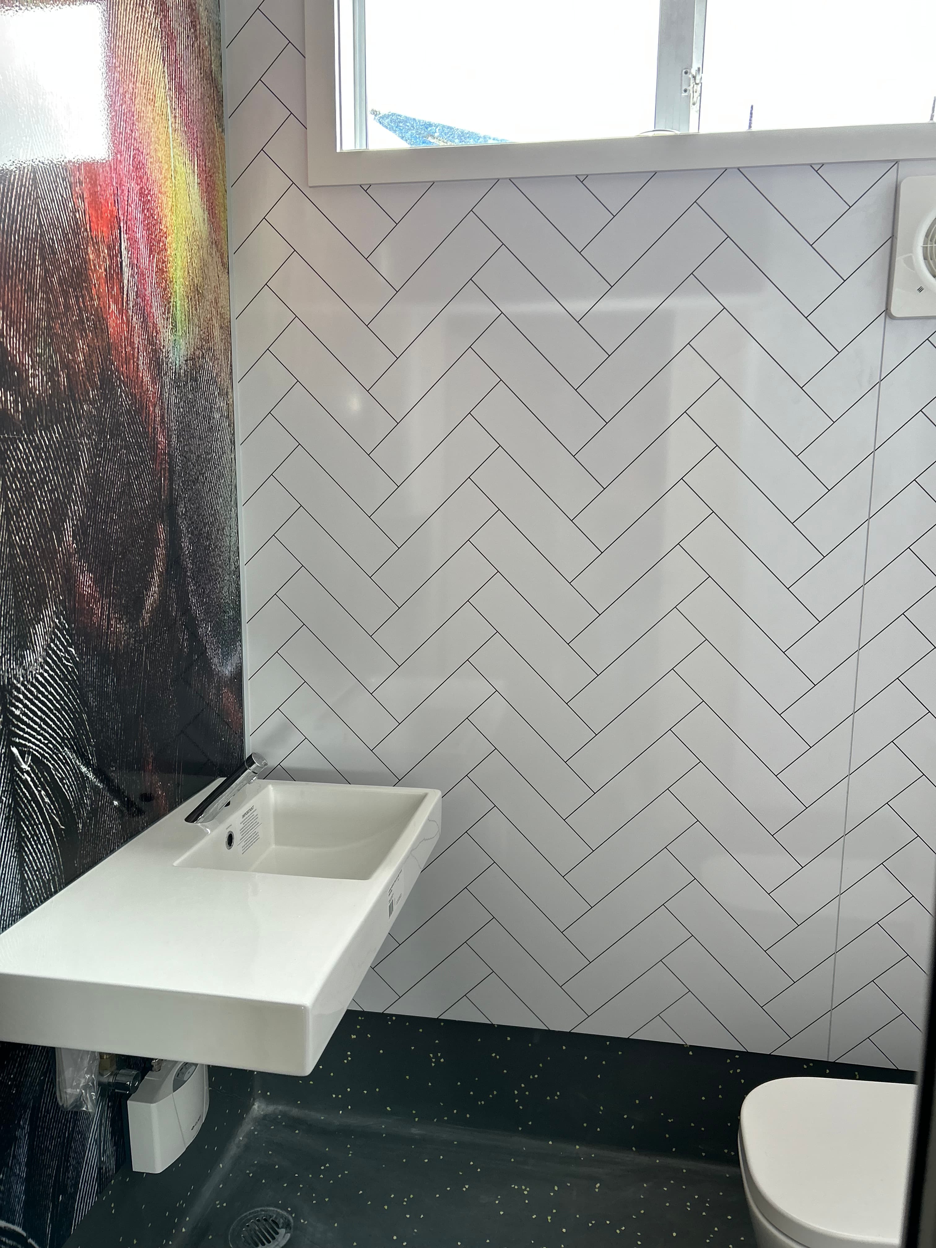 School bathroom featuring Hydratile herringbone custom design panels
